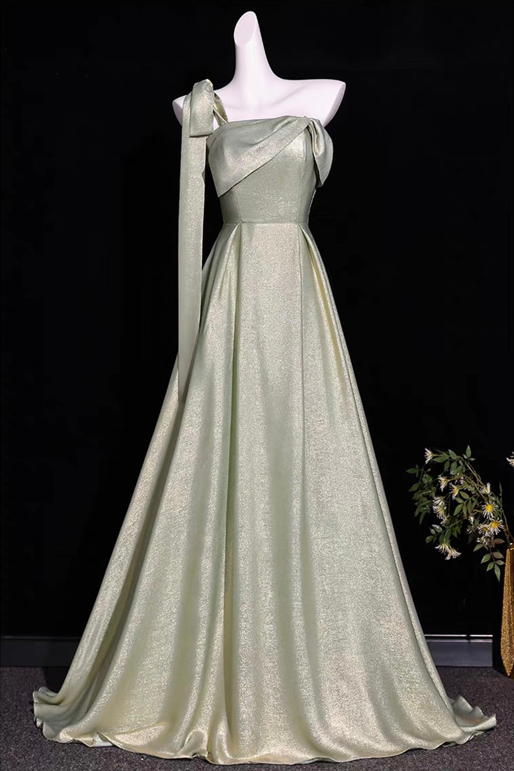 Sage Green Metallic One-Shoulder Gown with Sculptural Bow & Trailing Ribbon